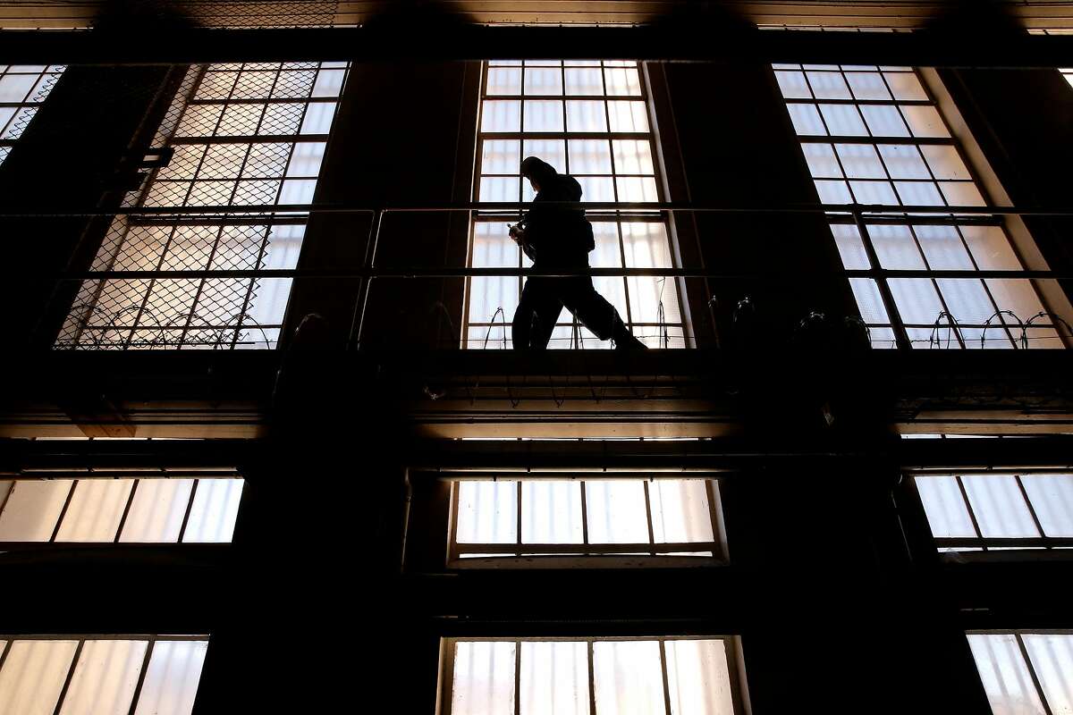 A guard on the catwalk above the cells of the condemned in East Block on death row at San Quentin State Prison on Tuesday December 29, 2015, in San Quentin, Calif.