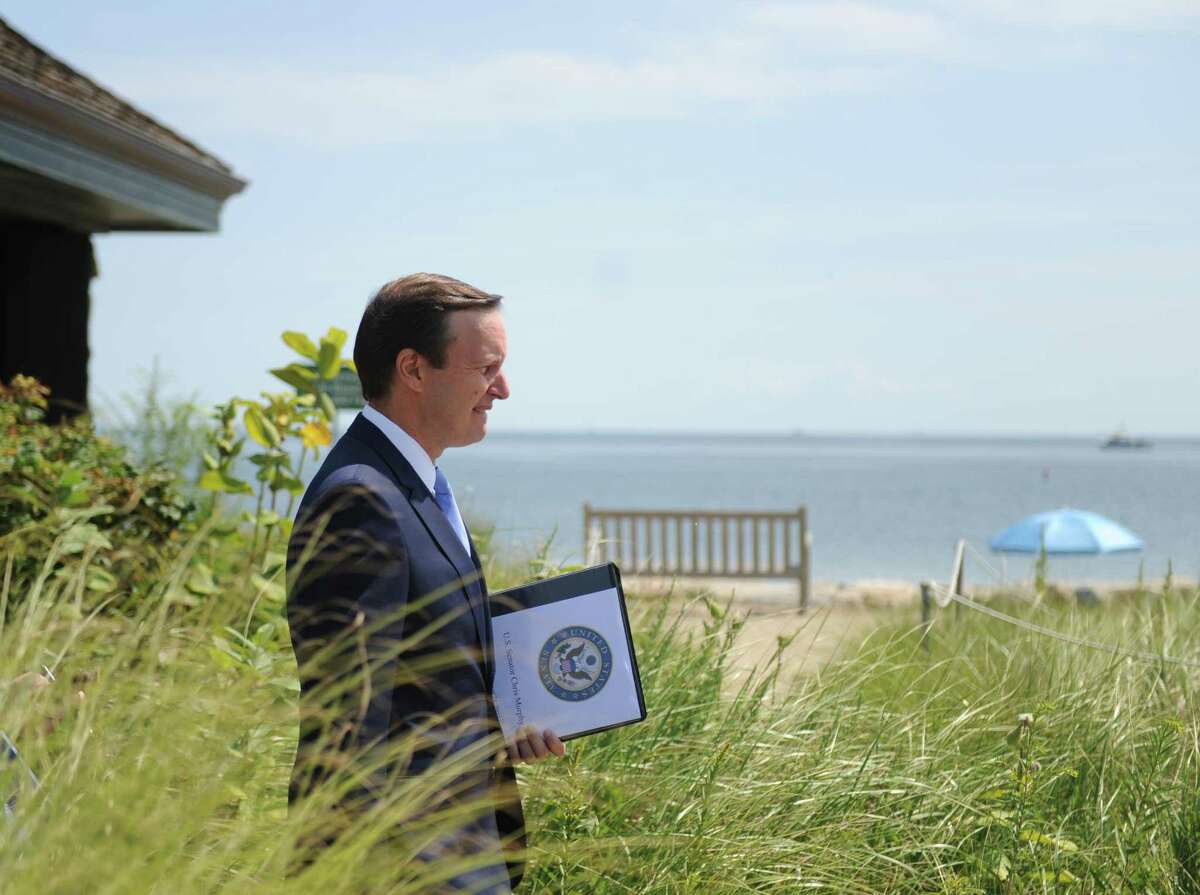 U.S. Sen. Chris Murphy walks near the beach after speaking about the Long Island Sound at Greenwich Point Park's Innis Arden Cottage in Old Greenwich, Conn. Thursday, Aug. 24, 2017. Sen. Murphy addressed President Trump's proposed Envirnomental Protection Agency budget cuts, which would eliminate the EPA's Long Island Sound program.