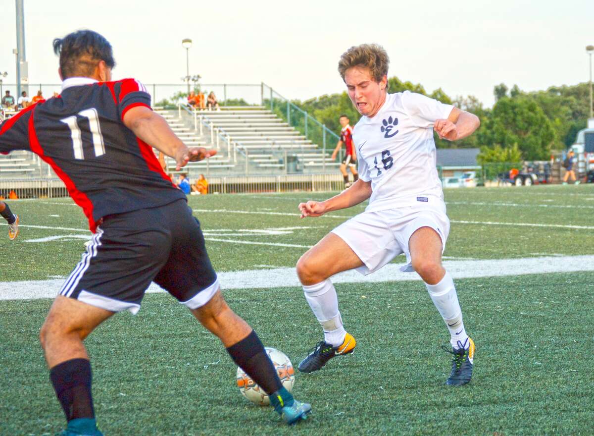 Edwardsville junior midfielder Josh Reed, right, plays defense in the first half of Thursday’s Southwestern Conference game against Granite City at the District 7 Sports Complex.