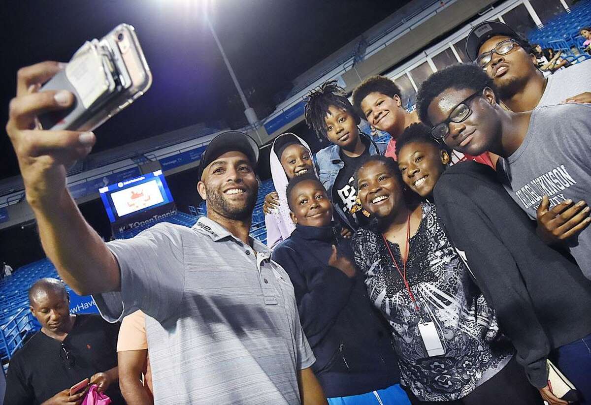 James Blake takes a selfie with Hall Neighborhood House in Bridgeport after defeating Michael Chang, Thursday evening, August 24, 2017, in the Men's Legends championship at the Connecticut Tennis Open at the Stadium Court at the Connecticut Tennis Center in New Haven. Blake, a Bridgeport native, won, 7-5. (Catherine Avalone/Hearst Connecticut Media)