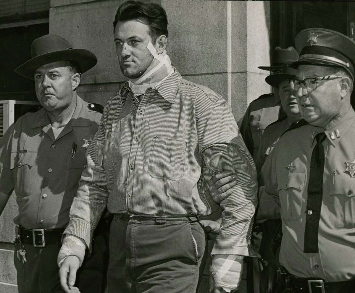 Francis Mainville is escorted by police during his arraignment on murder charges Sept. 1, 1967, for shooting Harry Pearlberg in Cohoes. He is bandaged after an attempted suicide. (Times Union archive)
