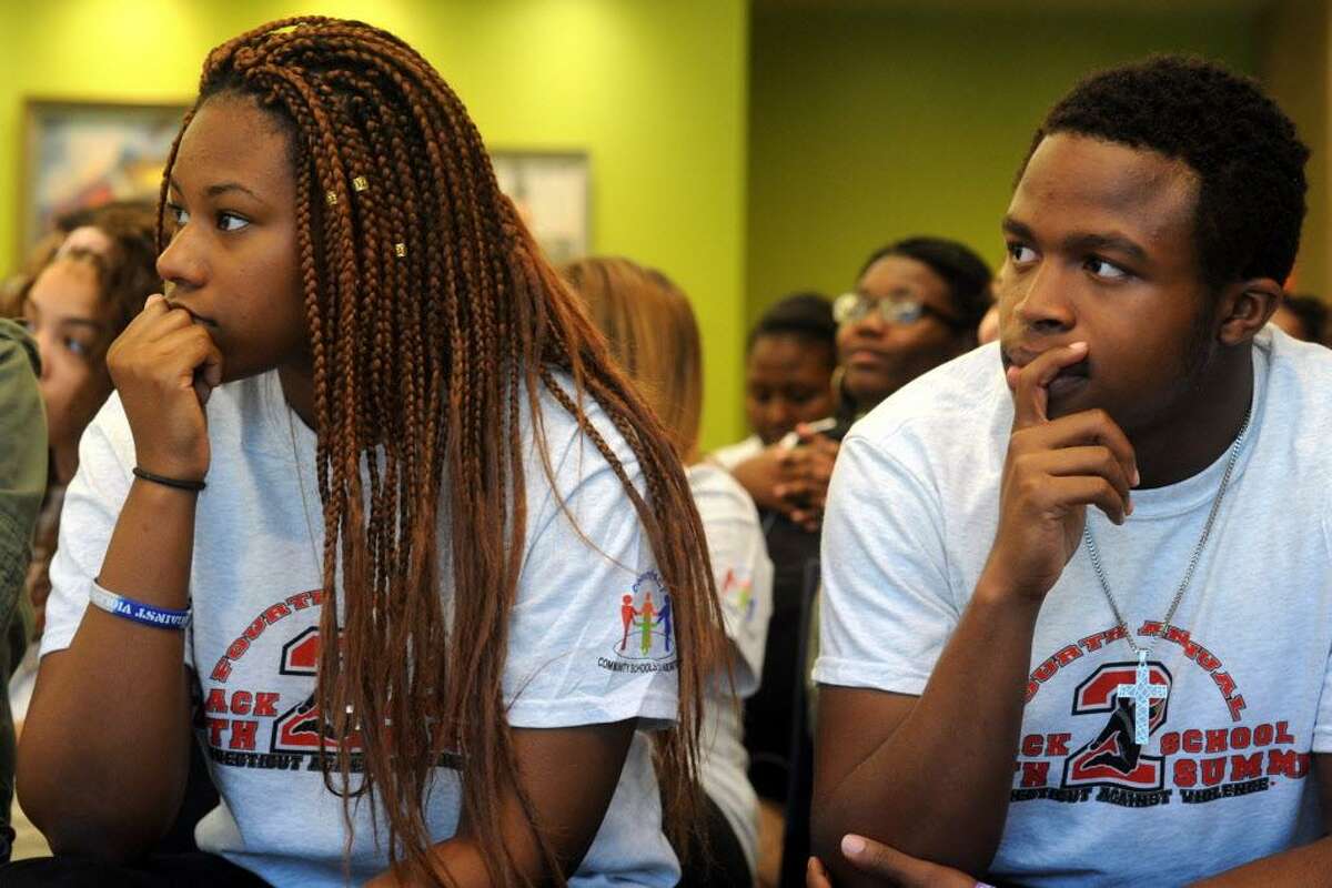 Ryanna Johnson and Caled Bailey, students from Fairchild Wheeler Interdistrict Magnet School listen to speakers at the Connecticut Against Violence 4th Annual Bridgeport Back to School Youth Summit, held at Housatonic Community College in Bridgeport, Conn. Sept. 23, 2016.