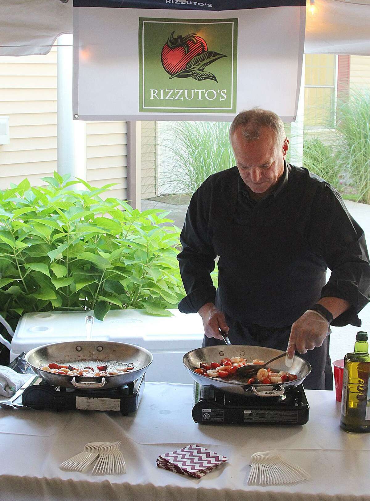 Bill Rizzuto of Rizzuto's served a variety of hot dishes at the Best of Bethel event held Wednesday, Aug. 23, 2017, at Bennett Memorial Park in Bethel, Conn.