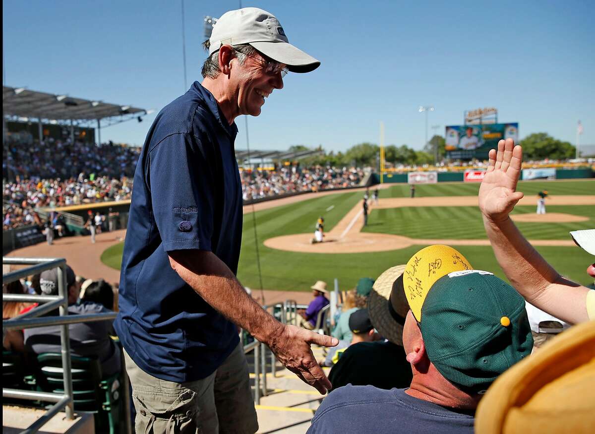 Oakland Athletics' General Manager Billy Beane visits with fan during Cactus League game against Chicago White Sox in Spring Training at Hohokam Stadium in Mesa, Arizona, on Sunday, March 8, 2015.