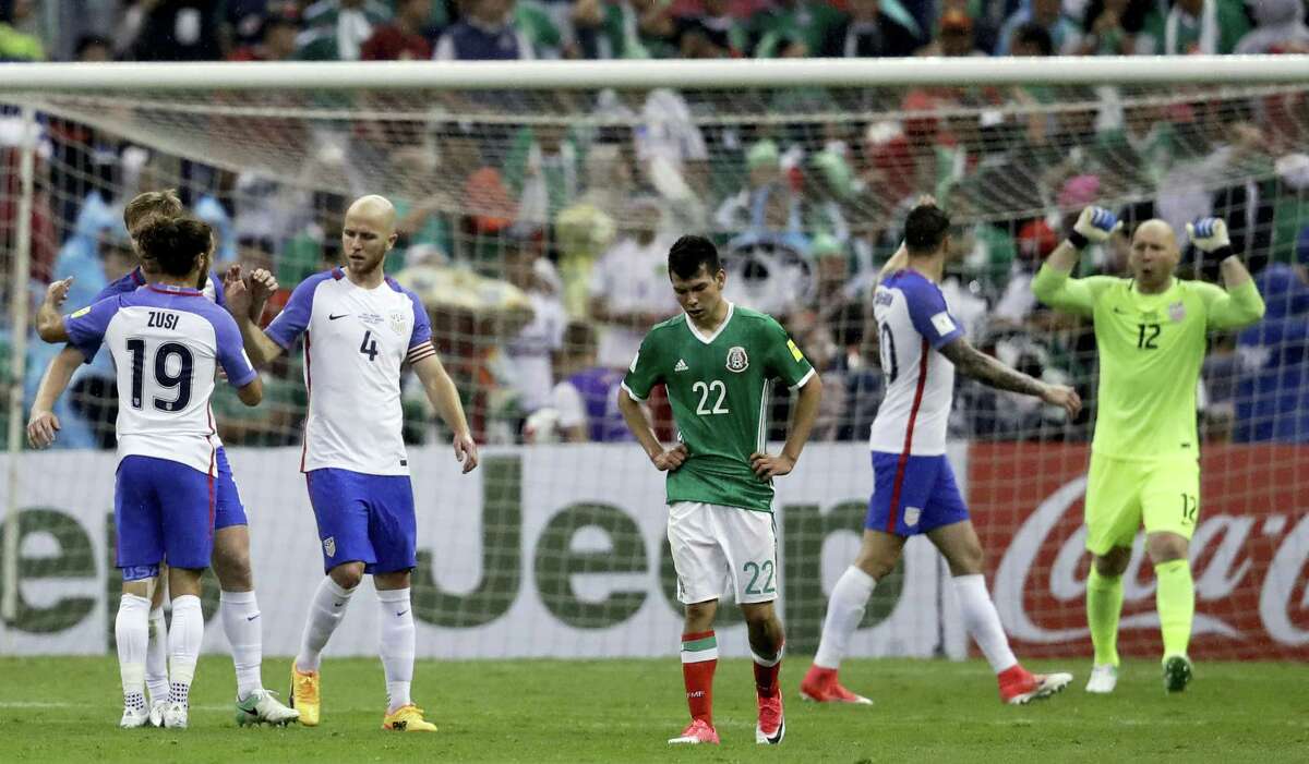 United States’ Michael Bradley (4), Graham Zusi (19) and goalkeeper Brad Guzan, right, celebrate at the end of their draw against Mexico at Azteca Stadium in Mexico City on Sunday.