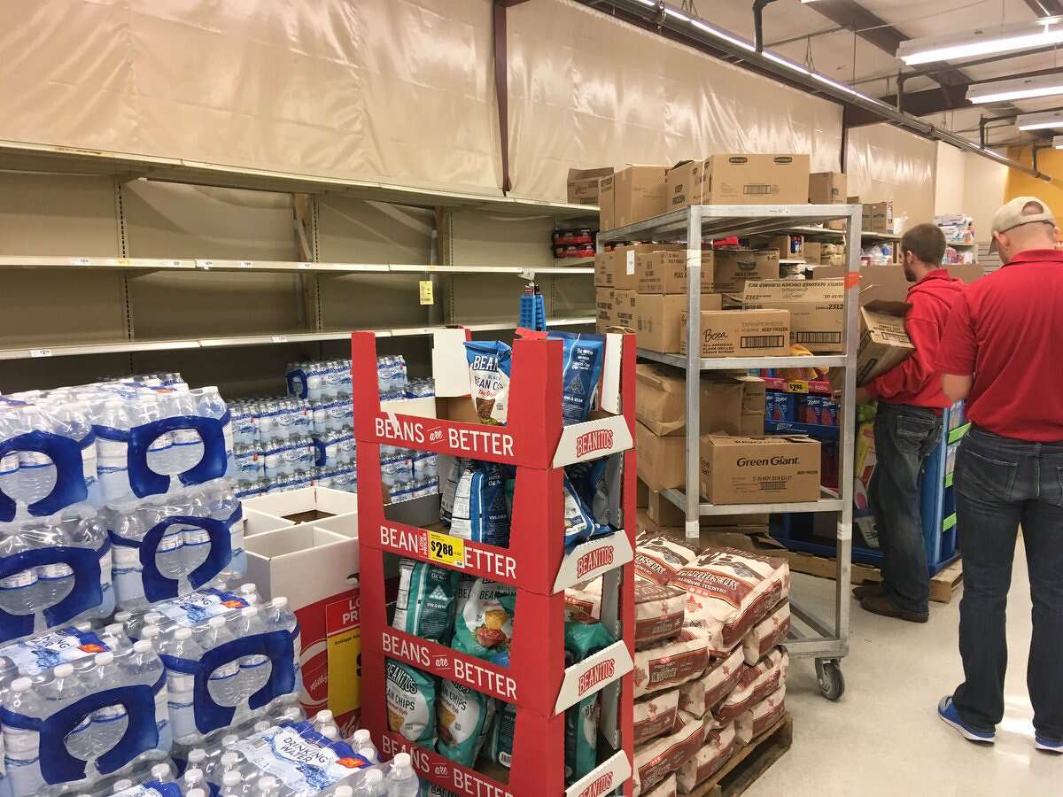 Workers restock water at the Lumberton H-E-B.   Tim Collins/The Enterprise