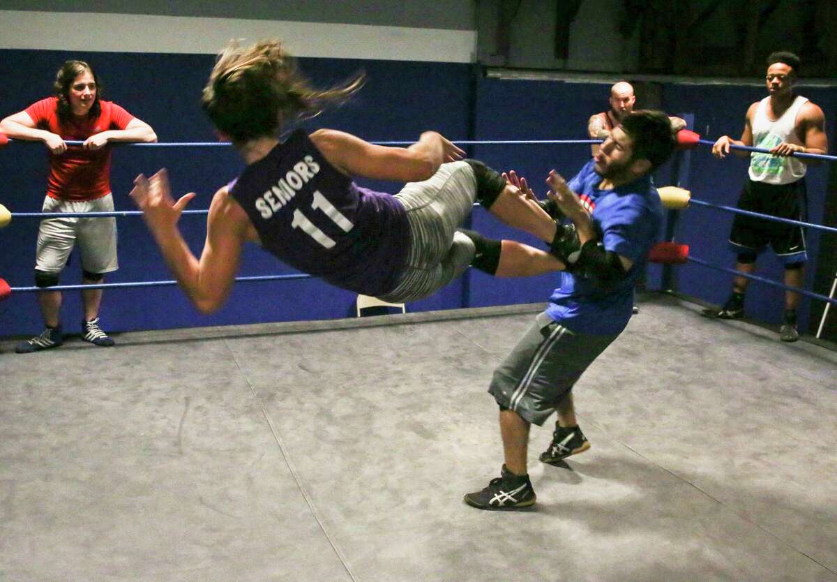 From top: Kylie Rae waits for her turn during training drills at Reality of Wrestling in Texas City; Rae wrestles Isaac Bhuiyan; the 24-year-old prepares to slam Robert Cantu; and she works on her moves with trainer Gino Medina.