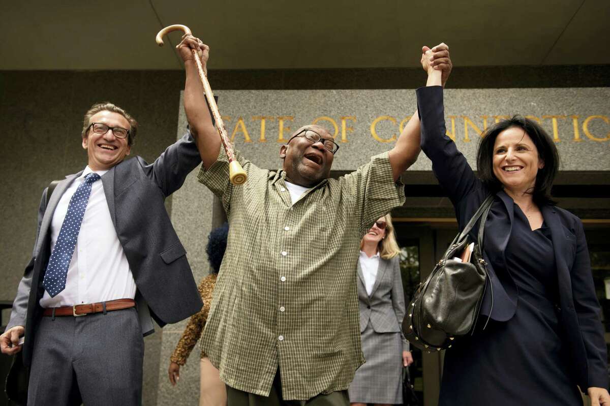 Shouting “Freedom,” Alfred Swinton, middle, walks out of Connecticut Supreme Court Thursday, June 8, 2017, in Hartford, Conn., with Innocence Project lawyers Chris Fabricant, left, and Vanessa Potkin after a Superior Court judge approved a new trial in his conviction in the 1991 murder of Carla Terry. After serving 18 years, Swinton, 68, was released on a promise to appear in court.