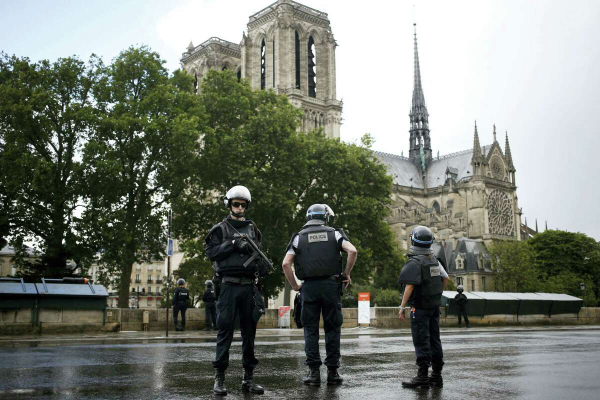 Police officers seal off the access to Notre Dame cathedral in Paris, France, Tuesday, June 6, 2017. Paris police say an unidentified assailant has attacked a police officer near the Notre Dame Cathedral, and the officer then shot and wounded the attacker.