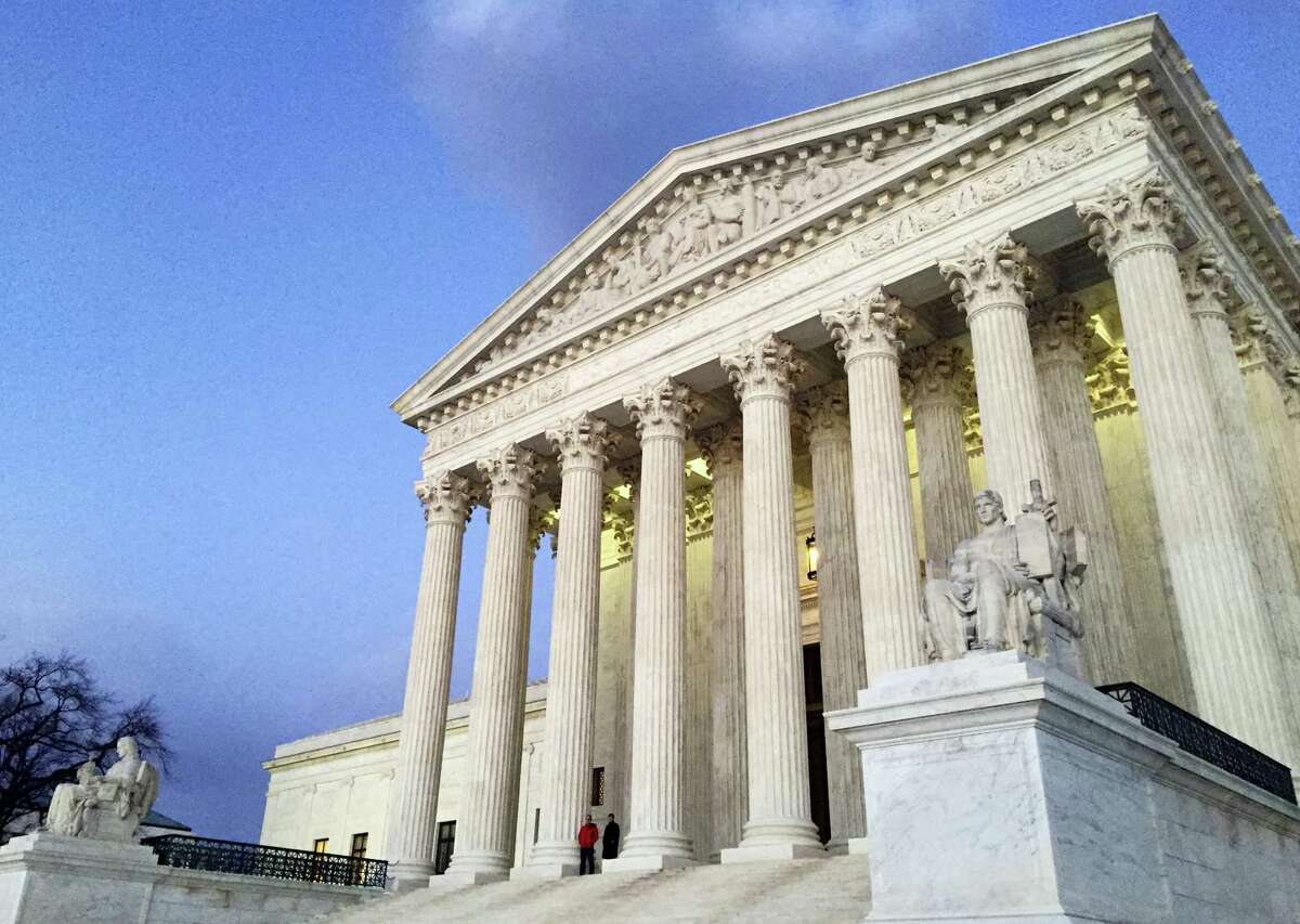 In this Feb. 13, 2016, file photo, people stand on the steps of the Supreme Court at sunset in Washington. The Trump administration made a plea to the Supreme Court on June 1, 2017, to let travel ban take effect