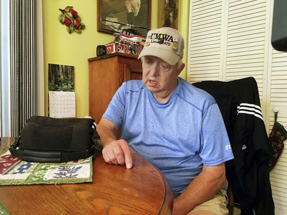 Retired coal miner Kenny Smith sits at his kitchen table in Centertown, Ky., Thursday, June 1, 2017, as he speaks during an interview. President Donald Trump announce Thursday during a news conference a decision to pull out of the landmark Paris climate accord. Smith worked in underground mines in western Kentucky until he retired in the 1990s after 22 years. He supports Trumps decision to pull out of the accord. Next to Smith on the table is the heart pump that keeps him alive.