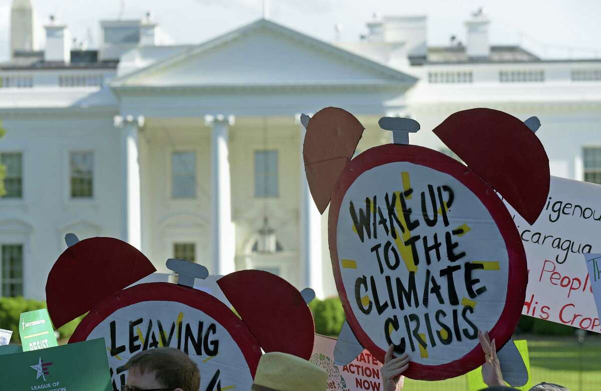 Protesters gather outside the White House in Washington, Thursday, to protest President Donald Trump’s decision to withdraw the Unites States from the Paris climate change accord. AP Photo — Susan Walsh