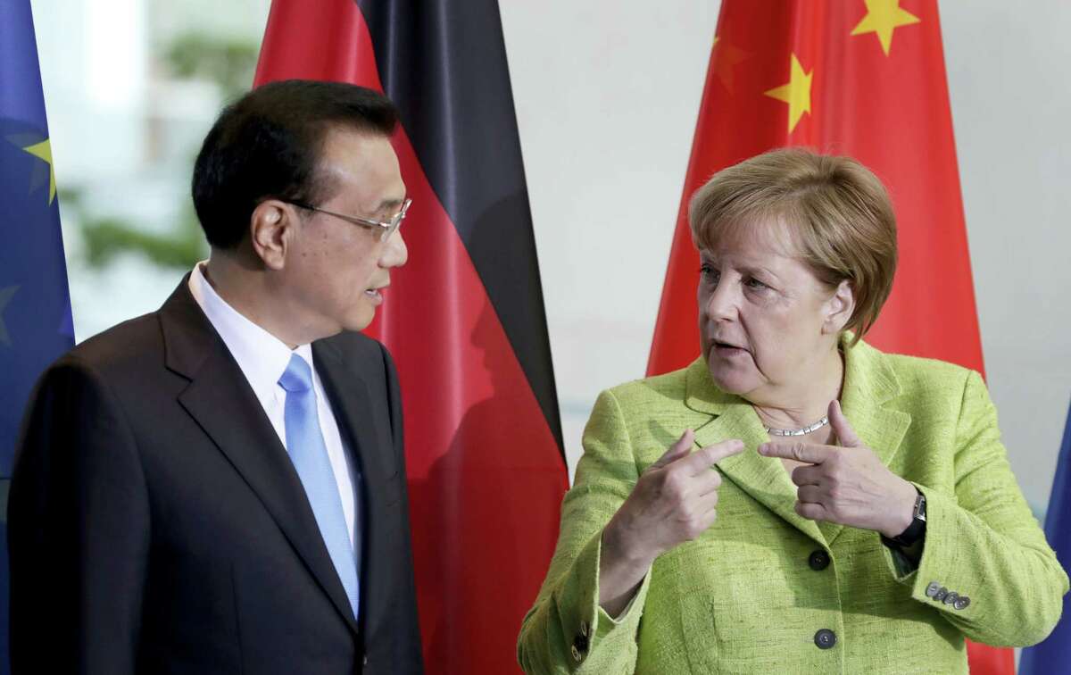 German Chancellor Angela Merkel, right, and China’s Premier, Li Keqiang, left, talk during a contract signing ceremony as part of a meeting at the chancellery in Berlin, Germany, Thursday, June 1, 2017.