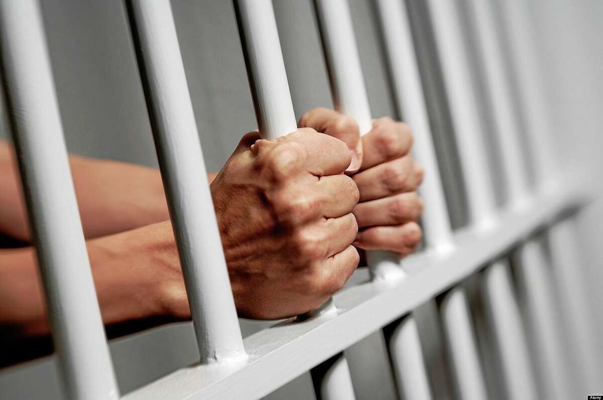 BXP06Y Hands on prison bars