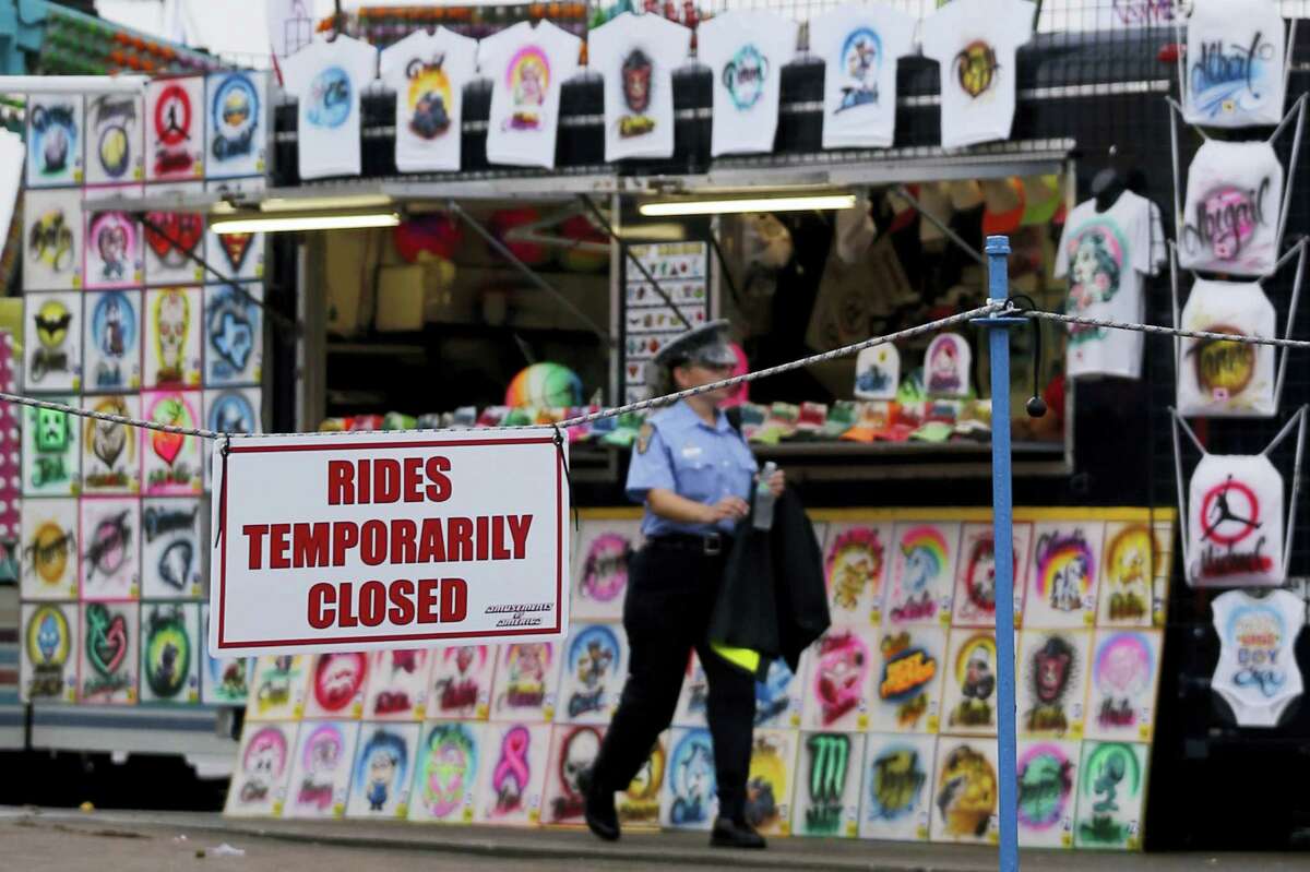 An Ohio State Highway Patrol cadet patrols the midway at the Ohio State Fair Thursday, July 27, 2017, in Columbus, Ohio. The fair opened Thursday but its amusement rides remained closed one day after Tyler Jarrell, 18, was killed and seven other people were injured when the thrill ride broke apart and flung people into the air.
