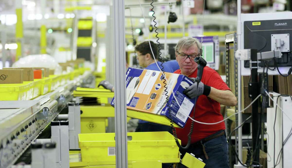 Mark Oldenburg processes outgoing orders at Amazon.com’s fulfillment center in DuPont, Wash.