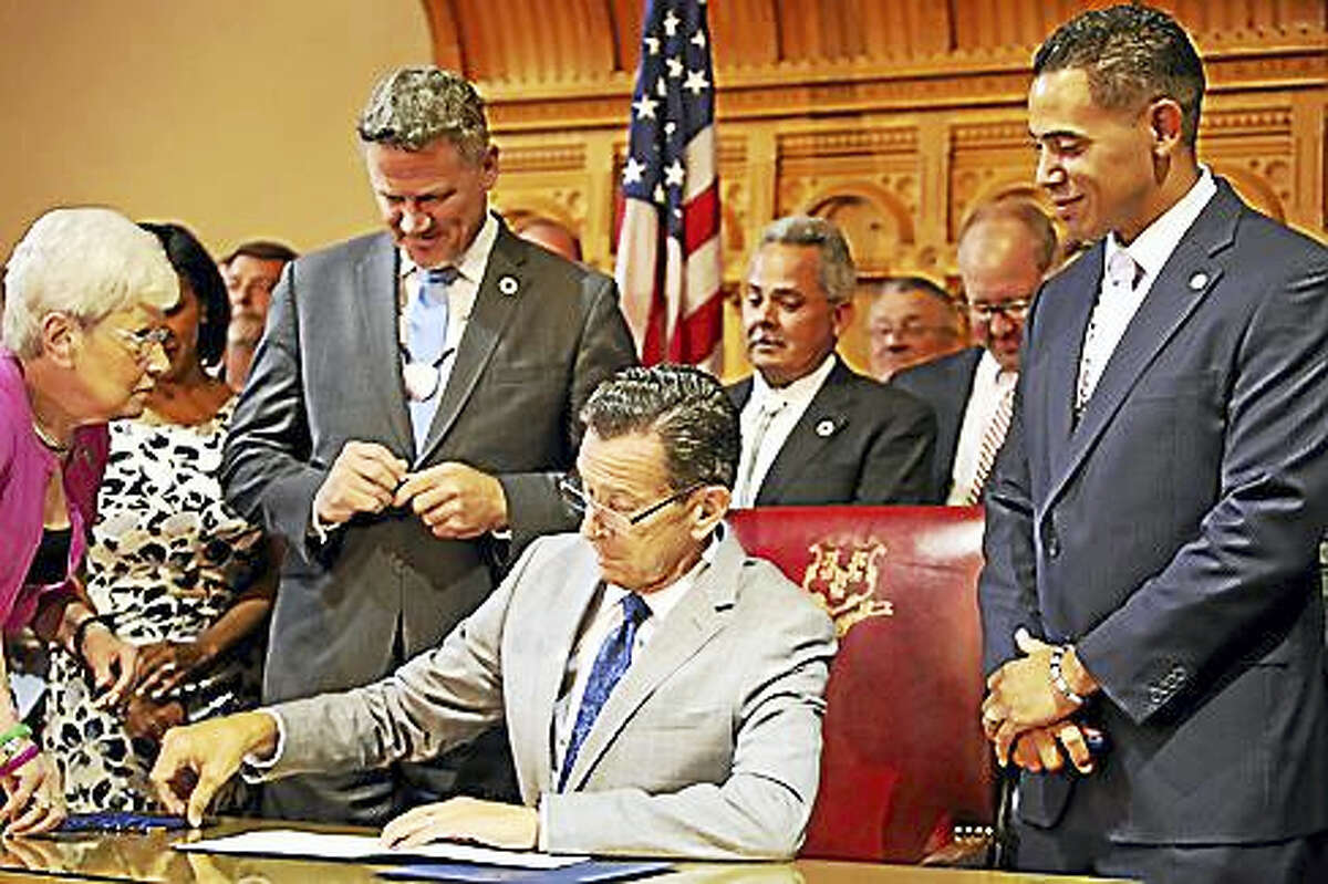 Gov. Dannel P. Malloy is bookended last week by Mohegan Chairman Kevin Brown and Mashantucket Pequot Chairman Rodney Butler.