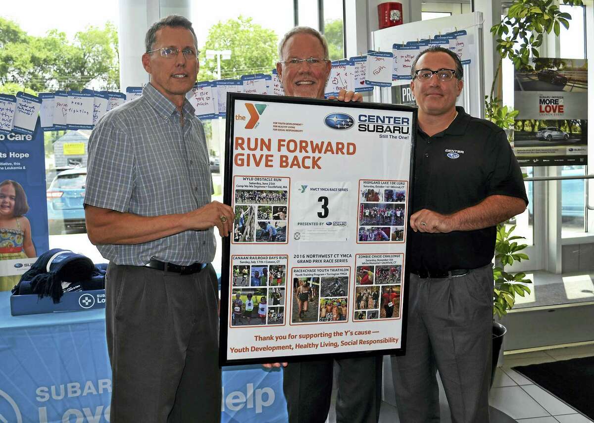 Photo Caption:On Friday, July 21, Northwest CT YMCA CEO Greg Brisco, left, presented Center Subaru Owner Phil Porter, middle, and General Manager Andy Maiolo with a special framed “Thank You” poster to honor the dealership’s continued support as the Presenting Sponsor of the Y’s Grand Prix Race Series. 2016 marked the third consecutive year Center Subaru was the main sponsor of the 4-event Race Series. The dealership is sponsoring the Race Series once again in 2017, with the next run being the Highland Lake 10K in Winsted on Oct. 7.