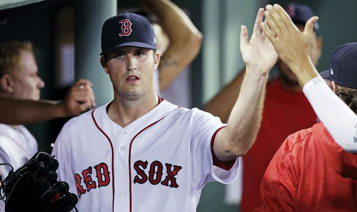 Boston Red Sox starting pitcher Drew Pomeranz is congratulated by teammates after being taken out of the game during the seventh inning at Fenway Park in Boston, on Wednesday. Pomeranz allowed three hits in his outing.