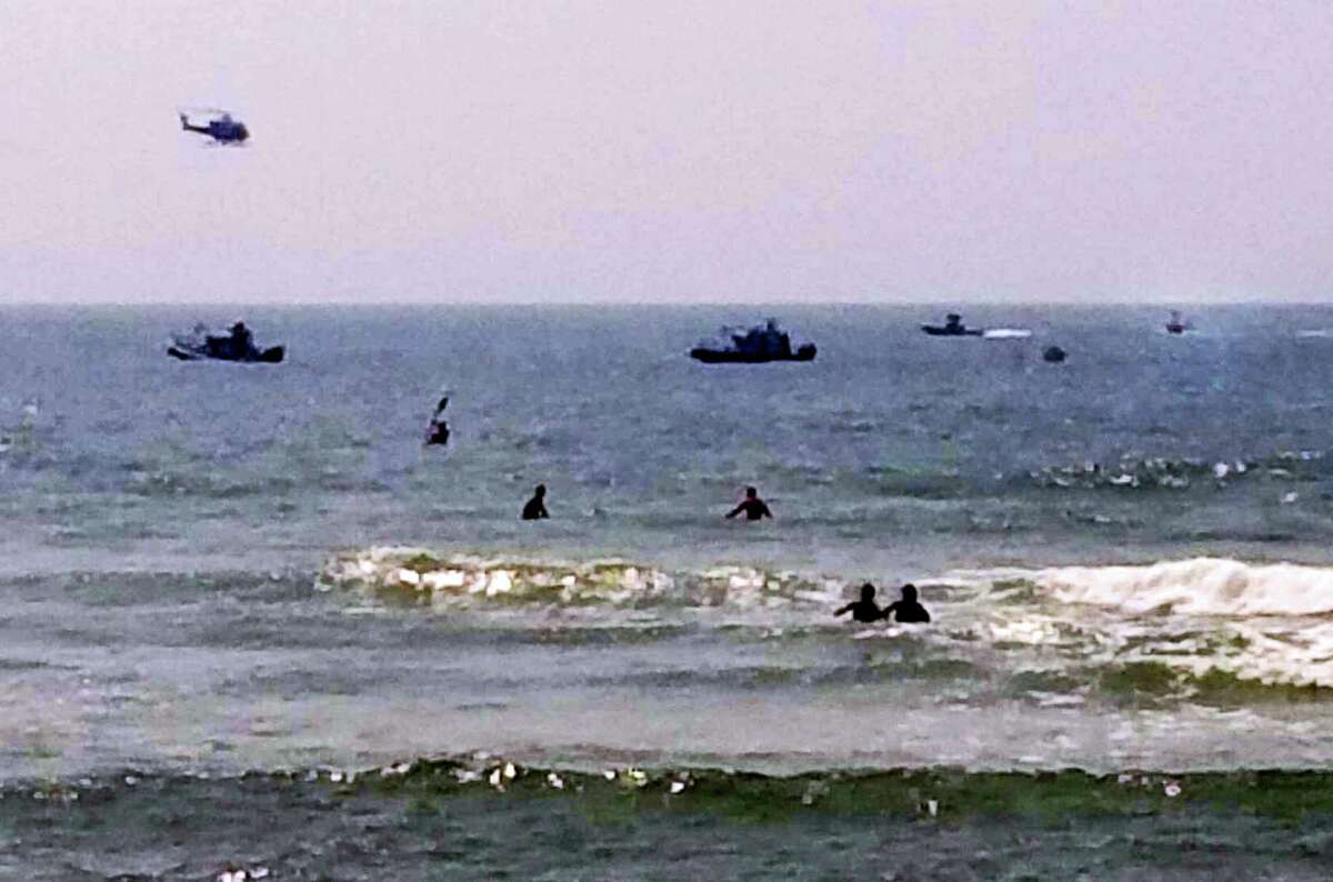 In this photo provided by ToniAnne Campasano Alvino, three rescue boats tow a helicopter that is almost entirely submerged, at far right, in the water off of Gilbo Beach, N.Y., on Long Island after the Robinson R 44 helicopter made an emergency ocean landing Wednesday, July 19, 2017. Shane McMahon, the son of World Wrestling Entertainment CEO Vince McMahon, was a passenger on the aircraft, and neither he, nor the pilot were hurt. The Federal Aviation Administration said the helicopter had taken off from Westchester County Airport in White Plains, N.Y.