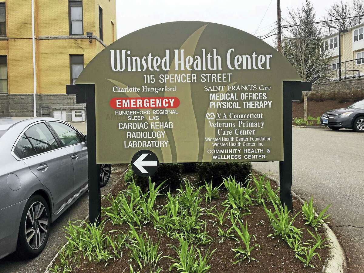Signs marking the offices of the Winsted Health Center and the Community Health & Wellness Center of Greater Torrington at 115 Spencer Street.