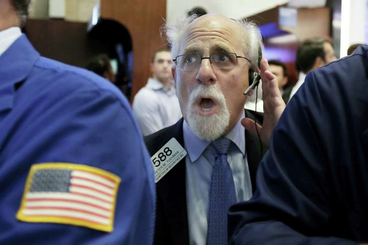 Trader Peter Tuchman works on the floor of the New York Stock Exchange Monday.