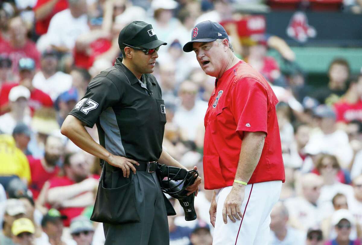 Boston Red Sox manager John Farrell argues with home plate umpire Gabe Morales during the fourth inning of the first game of a baseball doubleheader in Boston on July 16, 2017.