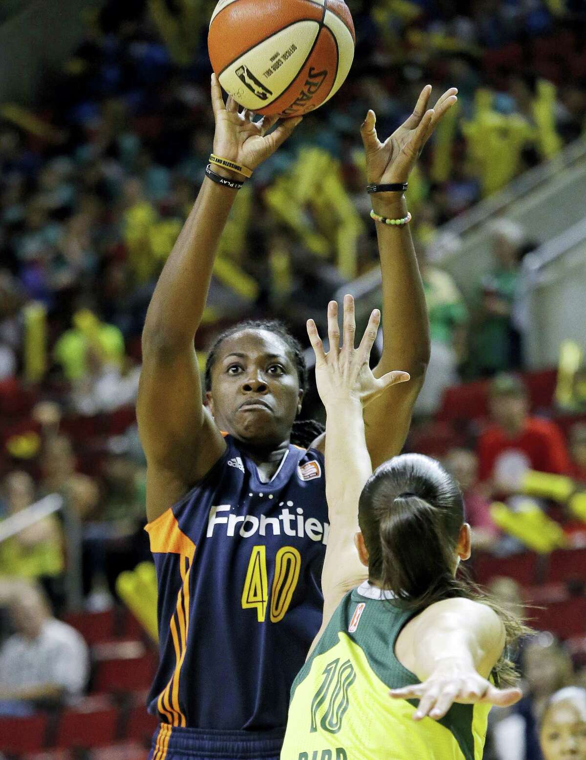 The Sun’s Shekinna Stricklen shoots over the Storm’s Sue Bird in the first half on Wednesday.