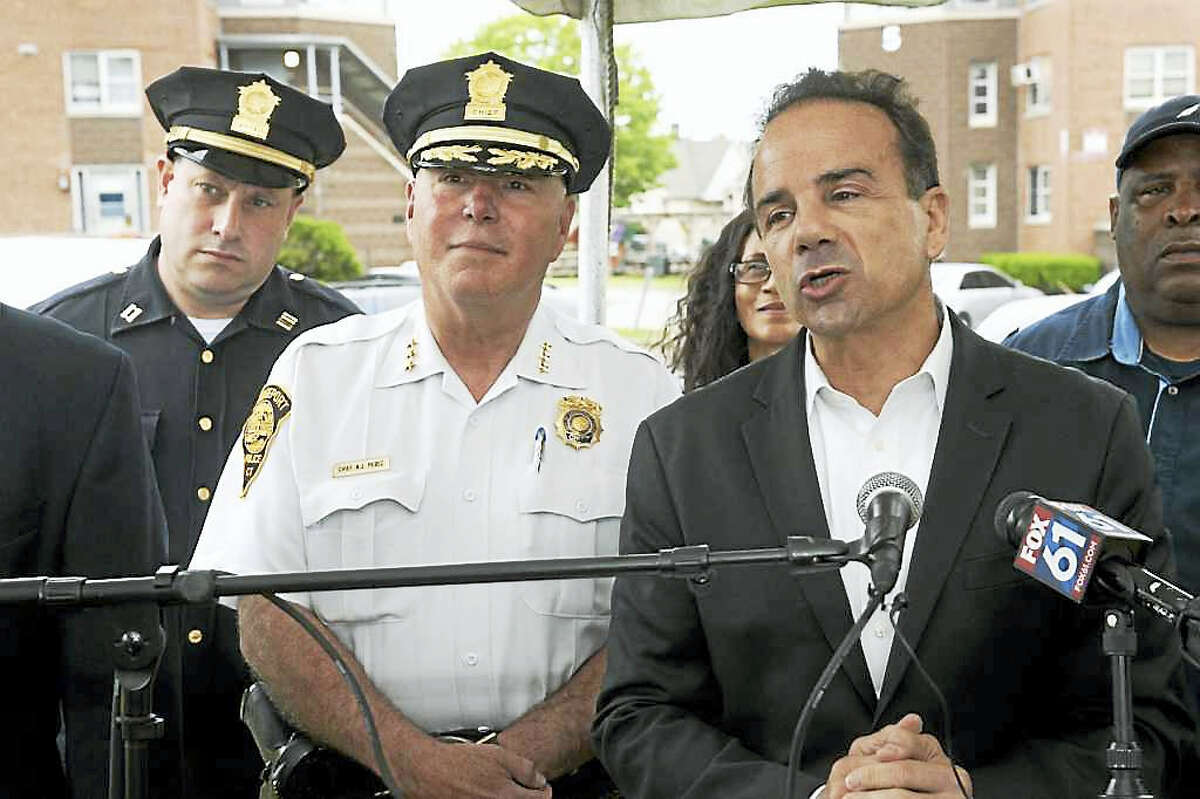 Bridgeport Mayor Joe Ganim, with Police Chief Armando ?A.J.? Perez, speaks at a press conference at the Charles F. Greene Homes in Bridgeport June 16.