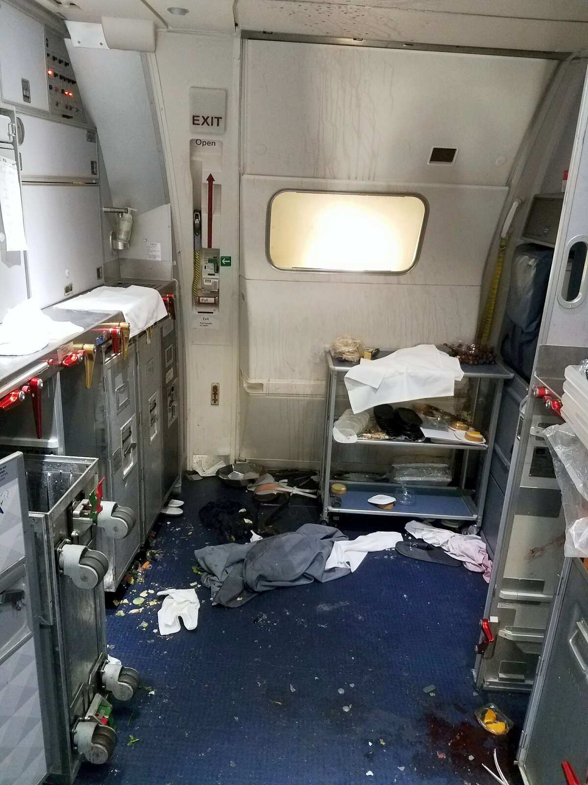 This Friday, July 7, 2017 photo taken the FBI and released via the U.S. Attorney’s Office in Seattle shows the aftermath of a cabin on Delta Flight 129 from Seattle to Beijing, after authorities say flight attendants struggled with Joseph Daniel Hudek IV, a passenger who lunged for an exit door. The photo was included in a criminal complaint filed Friday, July 7. The passenger is charged with interfering with a flight crew and faces up to 20 years in prison.