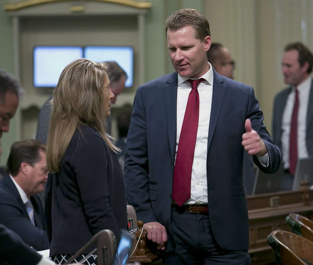 FILE-- Assembly Republican Leader Chad Mayes, of Yucca Valley, right, talks with fellow GOP Assembly member Marie Waldron, of Escondido, at the Capitol Monday, Aug. 21, 2017, in Sacramento. Lawmakers introduced a bill Thursday that gives Californians three years to file complaints with the state Department of Fair Employment and Housing over sexual harassment and discrimination in the workplace or in the housing market.