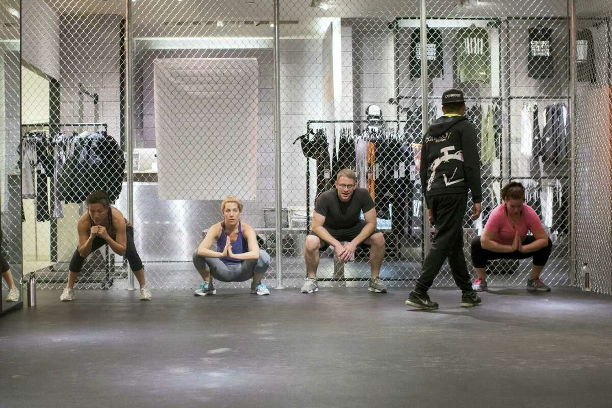 Coss Marte, second from right, conducts a workout class at ConBody Bootcamp Studio at The Wellery on the second floor of the Saks Fifth Avenue flagship store in New York.