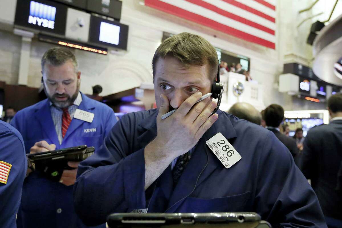 Traders Michael Milano, right, and Kevin Lodewick work on the floor of the New York Stock Exchange Thursday.