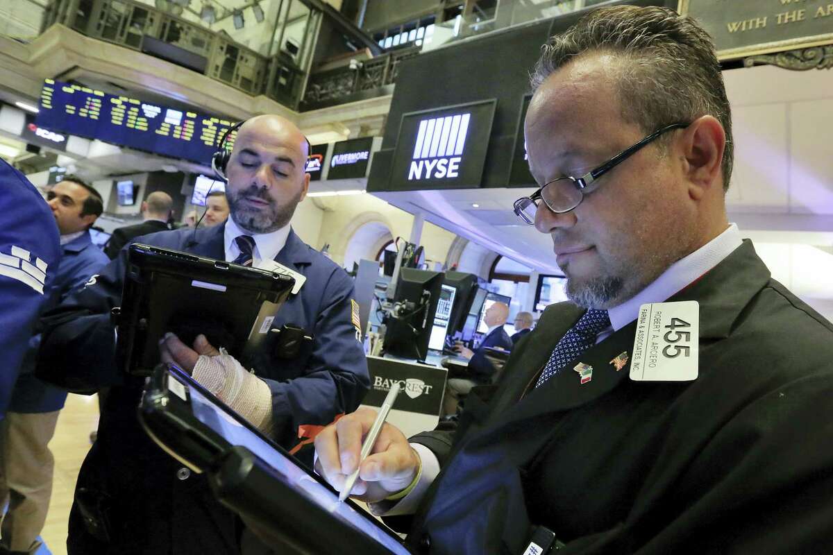 Traders Fred DeMarco, left, and Robert Arciero work on the floor of the New York Stock Exchange Thursday.