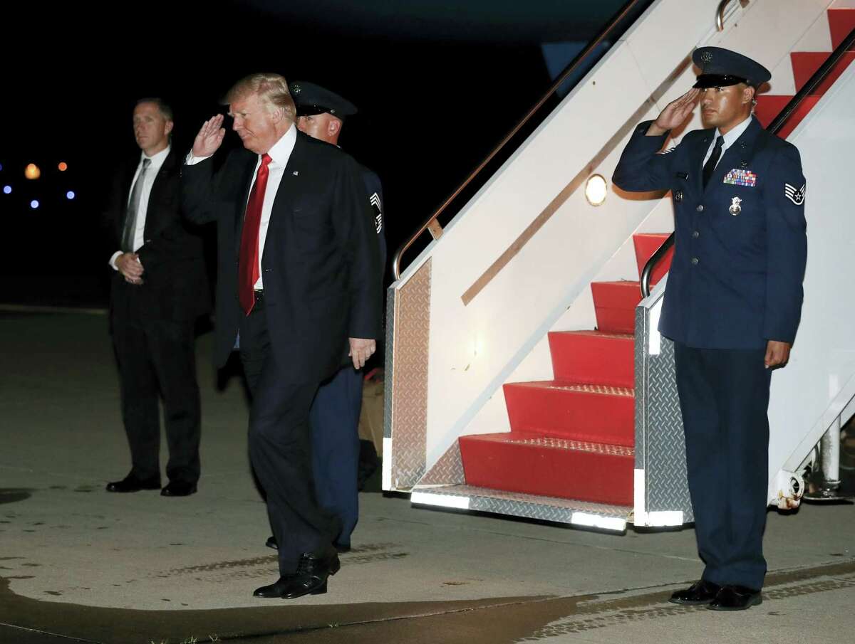 President Donald Trump salutes as he arrives on Air Force One at Morristown Municipal Airport, in Morristown, N.J. on July 1, 2017. Trump was en route to Trump National Golf Club in Bedminster, N.J., after attending an event at the Kennedy Center for the Performing Arts.