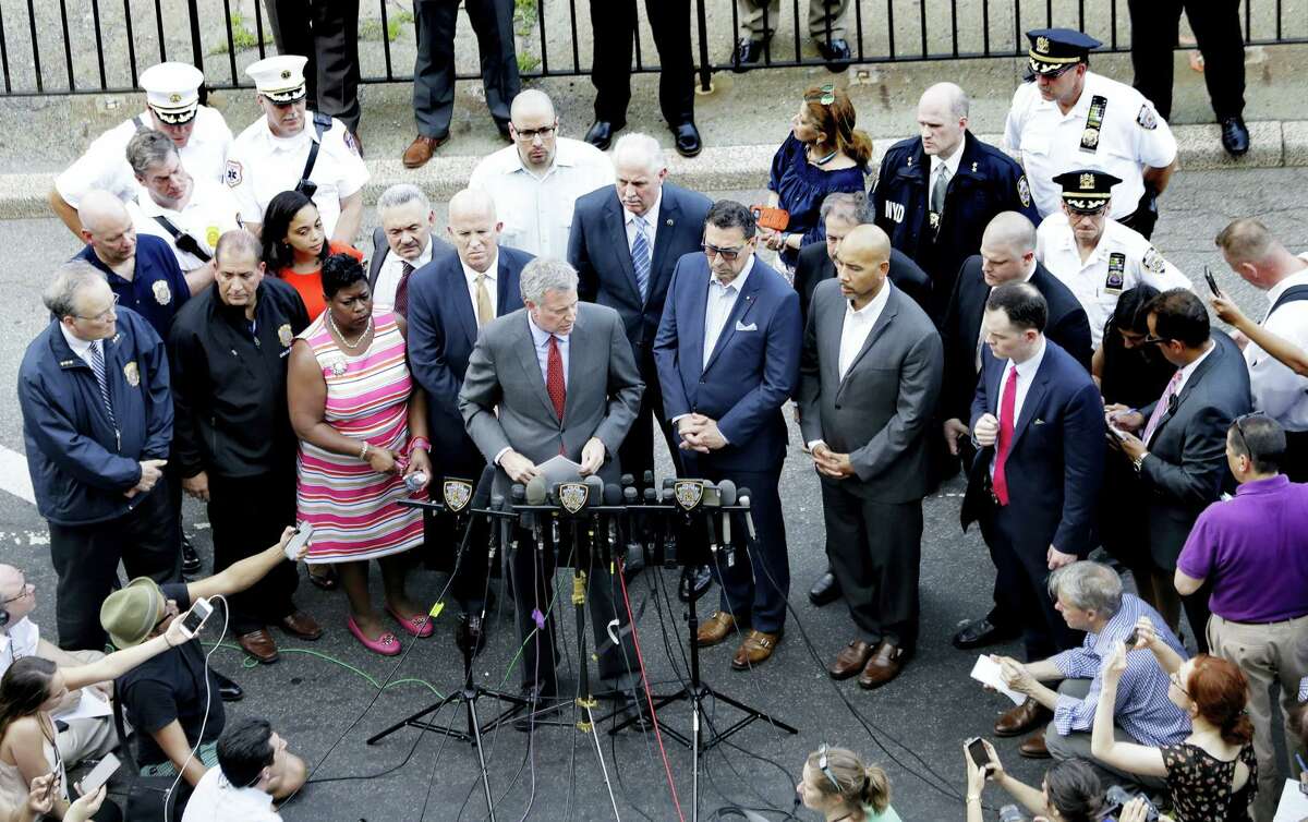 New York Mayor Bill De Blasio, center, talks during a news conference outside of the Bronx Lebanon Hospital Center after reports of a shooting, Friday, June 30, 2017, in New York.