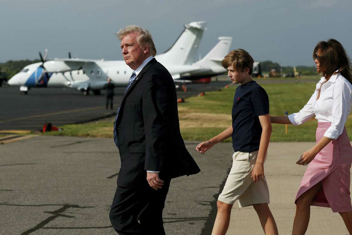 President Donald Trump, first lady Melania Trump, and their son Barron Trump, walk across the tarmac to Marine One as they arrive on Air Force One at Morristown Municipal Airport, in Morristown, N.J., Friday, June 30, 2017, en route to Trump National Golf Club in Bedminster, N.J.