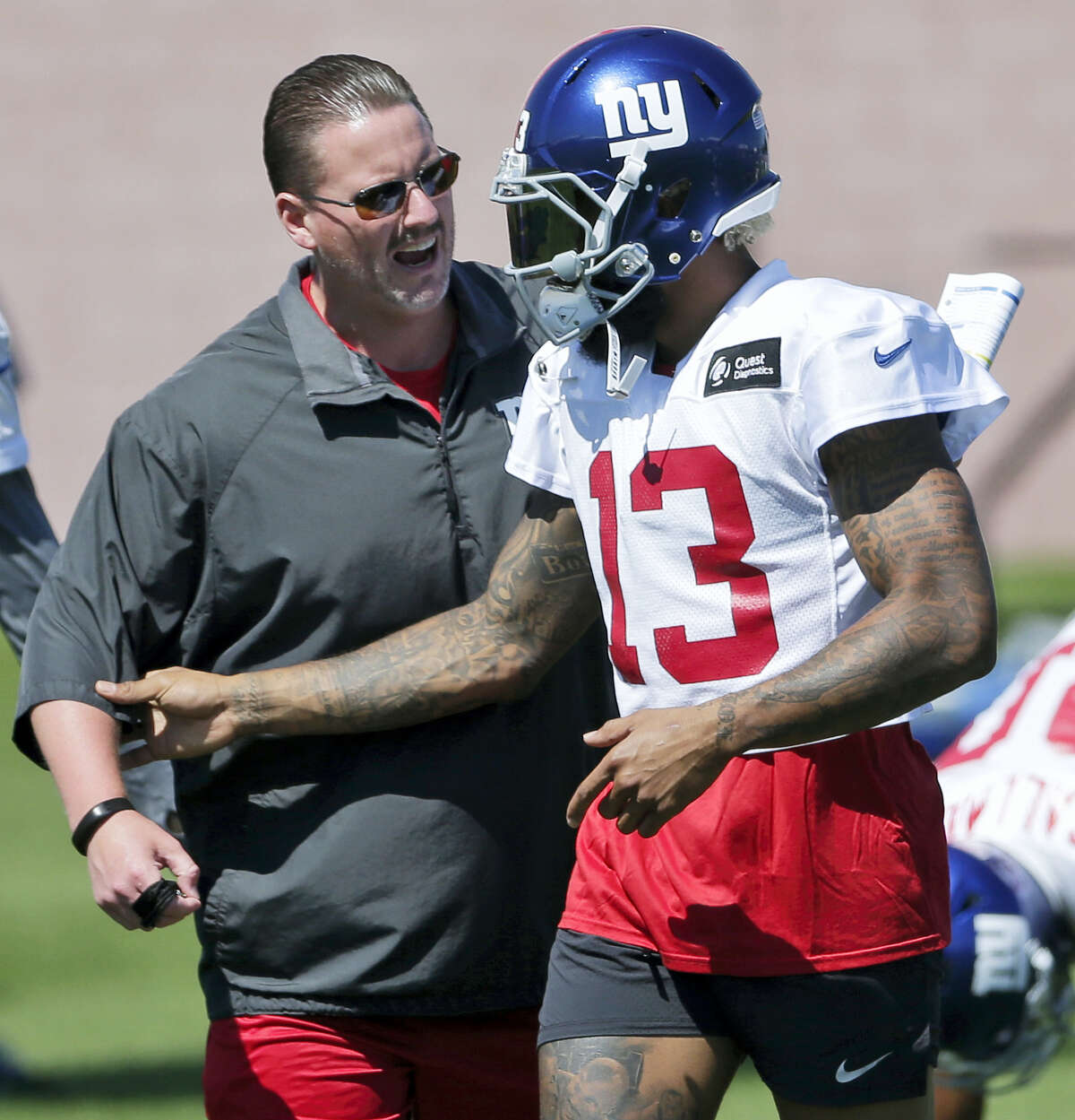 New York Giants head coach Ben McAdoo, left, talks with Odell Beckham, Jr. during training camp on Sunday.