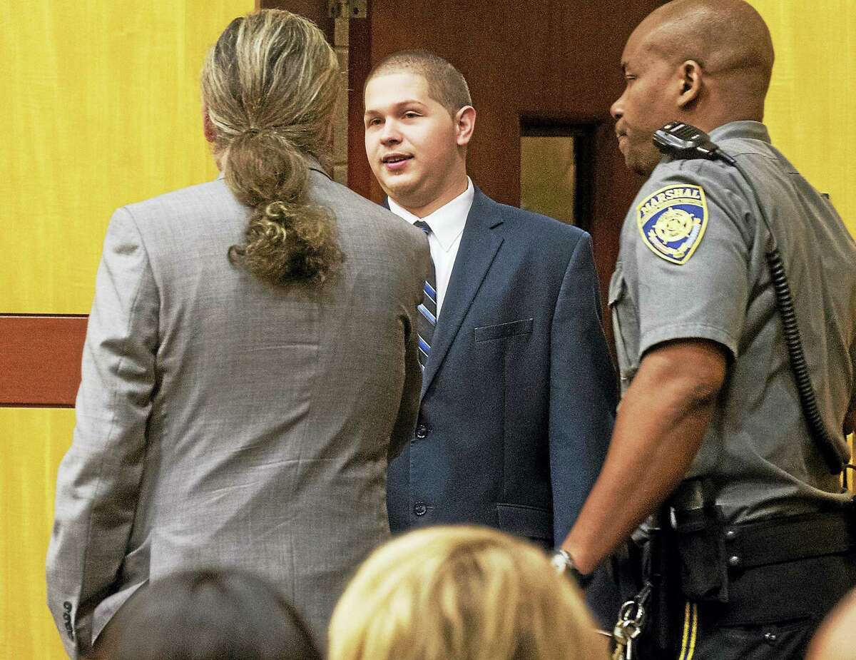 Tony Moreno, 23, is greeted by his attorney, Norm Pattis, as he enters the courtroom in Middlesex Superior Court on Wednesday to be sentenced. Moreno was found guilty of murder and risk of injury to a child in February after throwing his 7-month-old son Aaden to his death from the Arrigoni Bridge on July 5, 2015.