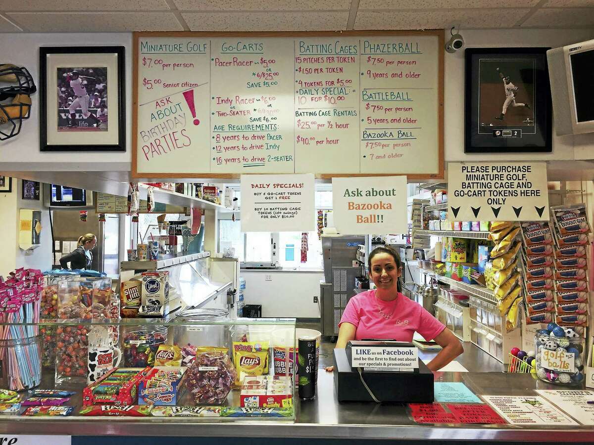 Rachel Gagnon stands behind the counter at R&B Sports World in Winsted Wednesday afternoon.