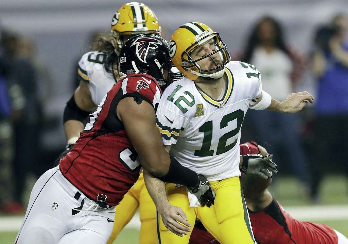 Atlanta Falcons defensive end Dwight Freeney (93) hits Green Bay Packers quarterback Aaron Rodgers after throwing a pass during the second half of the NFC championship game in Atlanta. Once the season is over, Freeney will think about his future. With his 37th birthday just weeks away, he knows time is running short.