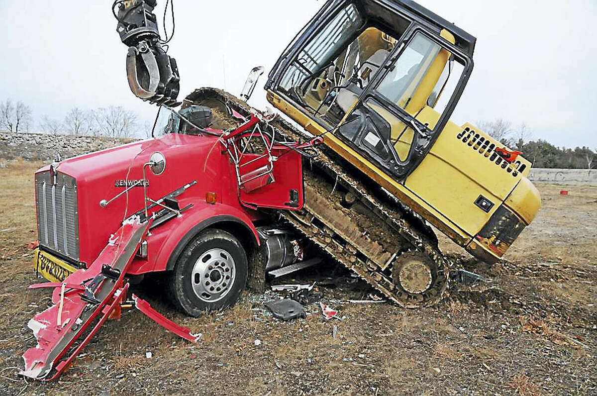 Photos of the aftermath of an incident where an excavator was used to crush a truck in Winsted, released by state police Thursday.