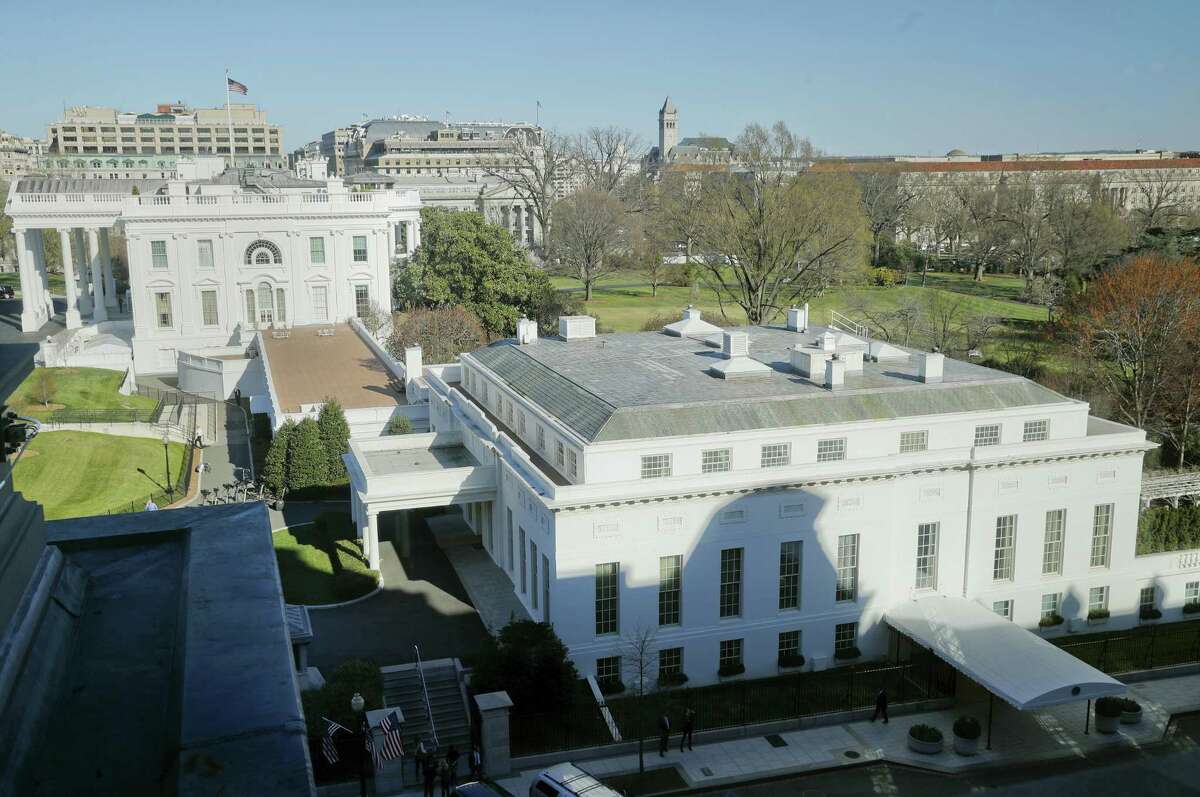 In this photo taken March 29, 2017, the main residence of the White House in Washington and the West Wing, right, as seen Wednesday from the Eisenhower Executive Office Building on the White House complex in Washington. A top White House communications staffer has resigned as President Donald Trump considers overhauling his White House staff over frustrations that his team is struggling to contain the burgeoning crisis involving alleged Russian meddling in the 2016 election.