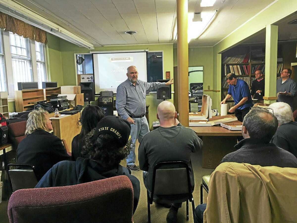 Photos by J. Timothy Quirk WAPJ volunteer John Ramsey leads an orientation discussion at WAPJ radio on Saturday in Torrington.