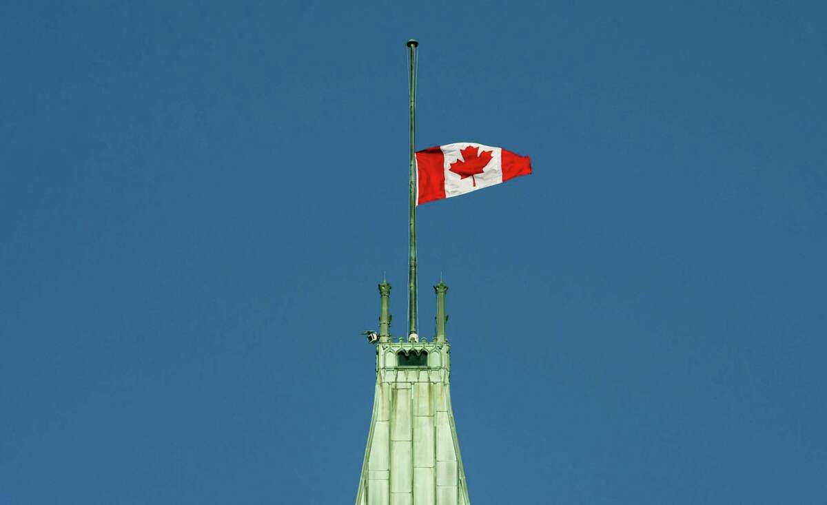 The flag flies at half-mast on the Peace tower Monday in Ottawa. It was announced Monday that the flag would fly at half-mast in memory of the victims of the Quebec City shooting.
