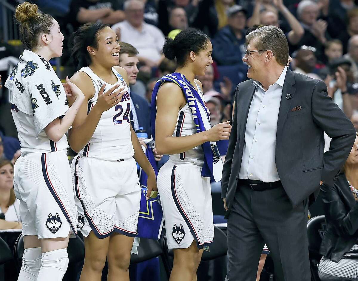 UConn coach Geno Auriemma, right, jokes with from left, Katie Lou Samuelson, Napheesa Collier and Gabby Williams during Monday’s win over Oregon.