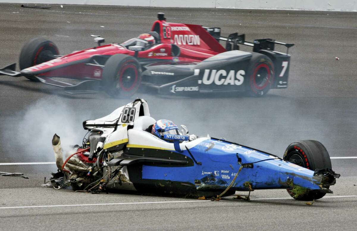 Scott Dixon, of New Zealand, sits in the remains of his car after going airborne in a crash during the running of the Indianapolis 500 auto race at Indianapolis Motor Speedway on Sunday, May 28, 2017 in Indianapolis.