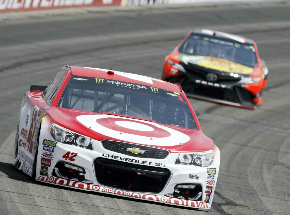 Kyle Larson, left, leads Martin Truex Jr. during Sunday’s race at Auto Club Speedway in Fontana, California, on Sunday.
