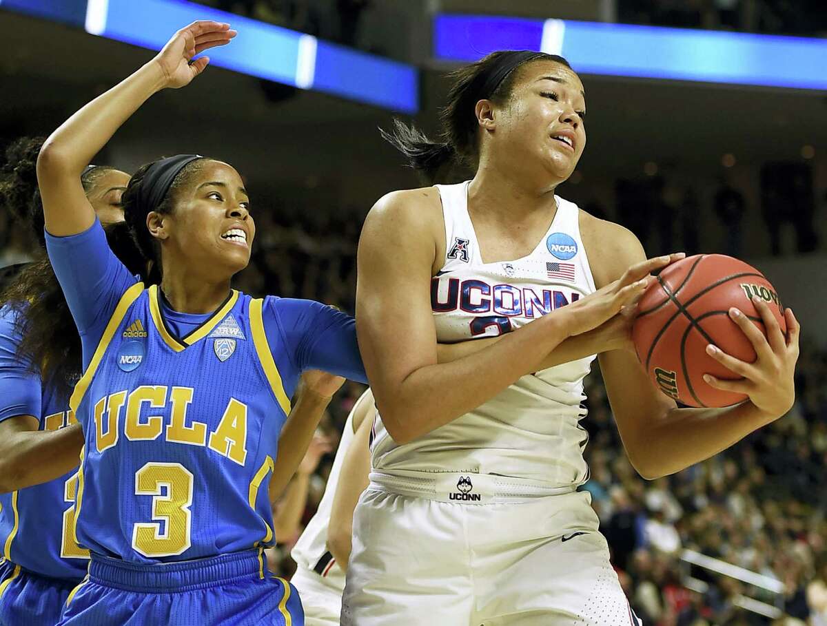 UConn’s Napheesa Collier, right, pulls down a rebound against UCLA’s Jordin Canada on Saturday.