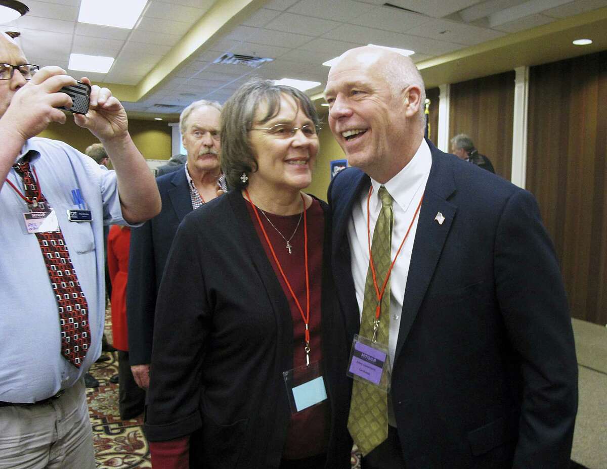 In this March 6, 2017 photo, Greg Gianforte, right, receives congratulations from a supporter in Helena, Mont. Montana voters are heading to the polls on May 25, 2017 to decide a nationally watched congressional election amid uncertainty in Washington over President Donald Trump’s agenda and his handling of the country’s affairs.